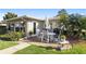 Cozy patio area with outdoor furniture, offering a peaceful space with lush landscaping at 7122 11Th W Ave, Bradenton, FL 34209