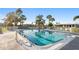Community pool offering lounge seating, palm trees and ample space for residents at 7122 11Th W Ave, Bradenton, FL 34209