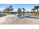 Beautiful community pool surrounded by mature landscaping and lounge seating at 7122 11Th W Ave, Bradenton, FL 34209
