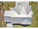 Aerial view showcasing metal roof, and a patio area surrounded by a well-kept lawn, offering a private retreat at 7150 Richardson Rd, Sarasota, FL 34240