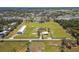Aerial view of the property showcasing a large lot, white metal building and additional acreage at 7150 Richardson Rd, Sarasota, FL 34240