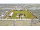 Expansive aerial view showcases the property's vast land, outbuildings, and serene pond with a marked property line at 7150 Richardson Rd, Sarasota, FL 34240