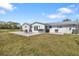Backyard showcases a concrete patio with furniture and built-in grill, ideal for outdoor dining and social gatherings at 7150 Richardson Rd, Sarasota, FL 34240