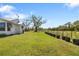 Expansive backyard with lush green lawn, privacy fence, and mature tree, perfect for outdoor enjoyment at 7150 Richardson Rd, Sarasota, FL 34240