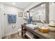 Bathroom features a white vanity with a wood countertop, a mirror, and neutral walls at 7150 Richardson Rd, Sarasota, FL 34240