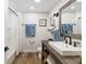 Bathroom featuring wood floors, modern fixtures, a vanity, and a walk-in shower at 7150 Richardson Rd, Sarasota, FL 34240