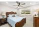 Bedroom features a bed with a wicker headboard, side tables, and neutral walls at 7150 Richardson Rd, Sarasota, FL 34240