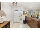 Bright foyer with views to the backyard features light walls, white floors, and adjacent sitting area at 7150 Richardson Rd, Sarasota, FL 34240