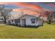 Charming single-story home with fresh exterior paint, blue awnings and beautifully landscaped front yard at 7150 Richardson Rd, Sarasota, FL 34240