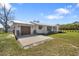 Home featuring an attached garage, metal roof, and well-kept lawn, blending practicality with suburban charm at 7150 Richardson Rd, Sarasota, FL 34240