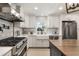 Bright kitchen features white cabinets, stainless steel appliances, and a farmhouse sink at 7150 Richardson Rd, Sarasota, FL 34240