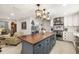 Spacious kitchen with a large island, stainless hood, and modern pendant lighting at 7150 Richardson Rd, Sarasota, FL 34240