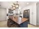 Bright, modern kitchen boasts white cabinets, a butcher block island, stainless steel appliances, and chic pendant lighting at 7150 Richardson Rd, Sarasota, FL 34240