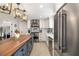 Open kitchen boasts stainless appliances, a central island, and stylish light fixtures at 7150 Richardson Rd, Sarasota, FL 34240