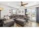 Comfortable living room with a large sectional, wood floors, and natural light at 7150 Richardson Rd, Sarasota, FL 34240