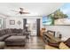Cozy living room featuring a large sectional, a ceiling fan, and a flatscreen TV at 7150 Richardson Rd, Sarasota, FL 34240