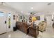 Bright living room boasts a comfortable brown leather sofa, neutral walls and flooring, and views to the outside at 7150 Richardson Rd, Sarasota, FL 34240
