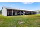 Large metal outbuilding provides ample covered parking and storage on grassy lot, perfect for equipment or vehicles at 7150 Richardson Rd, Sarasota, FL 34240