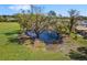 Scenic pond with mature trees, enhancing the natural beauty and tranquility of the landscape at 7150 Richardson Rd, Sarasota, FL 34240