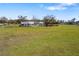 Idyllic country property with cozy home, fenced acreage, and rows of potted plants along the perimeter at 7150 Richardson Rd, Sarasota, FL 34240