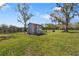 An old wooden shed surrounded by mature trees and a rustic fence, adding charm and character to the landscape at 7150 Richardson Rd, Sarasota, FL 34240