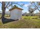 View of a metal utility shed with a simple door, providing extra storage and functionality on the property at 7150 Richardson Rd, Sarasota, FL 34240