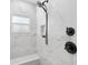 Shower with white marble tile, a corner seat, and oil rubbed bronze fixtures at 7150 Richardson Rd, Sarasota, FL 34240