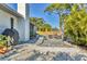 Picturesque backyard featuring a brick patio, grill, outdoor seating, and lush landscaping at 7612 4Th Avenue Nw Dr, Bradenton, FL 34209