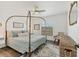 Comfortable bedroom featuring a four-poster bed, ceiling fan, and cozy seating area at 7612 4Th Avenue Nw Dr, Bradenton, FL 34209