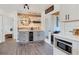 This kitchen features modern cabinets, wine fridge, rustic wood accents, and a charming gather sign at 7612 4Th Avenue Nw Dr, Bradenton, FL 34209