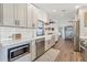 Modern kitchen with white subway tile, stainless steel appliances, and a view into the living area at 7612 4Th Avenue Nw Dr, Bradenton, FL 34209