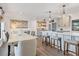This kitchen and dining room features wood floors, modern table, bar stools and rustic accents at 7612 4Th Avenue Nw Dr, Bradenton, FL 34209
