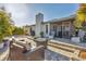 Serene backyard featuring a stone patio, outdoor seating, and lush landscaping at 7612 4Th Avenue Nw Dr, Bradenton, FL 34209