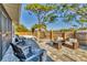 Outdoor patio features brick pavers, comfortable lounge furniture, and a view of the lush landscaping at 7612 4Th Avenue Nw Dr, Bradenton, FL 34209