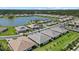 Scenic aerial view of homes near a lake, showcasing the community and natural beauty at 780 Ibiza Loop, Venice, FL 34292