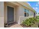 Charming front entrance with a blue door, brick path, and manicured landscaping at 780 Ibiza Loop, Venice, FL 34292