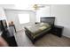 Cozy bedroom with a large window, wood-look flooring, and ample closet space at 3900 Roxane Blvd # 10A, Sarasota, FL 34235