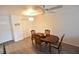 Dining area with wood-look flooring, dining table, ceiling fan, and closet space at 3900 Roxane Blvd # 10A, Sarasota, FL 34235