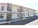 Condo exterior features stone accents, white paint, railings, and ample parking at 3900 Roxane Blvd # 10A, Sarasota, FL 34235