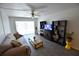 Living room featuring wood-look flooring, neutral decor, a ceiling fan and sliding doors at 3900 Roxane Blvd # 10A, Sarasota, FL 34235