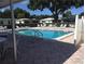 Community pool area with lounge chairs at 3900 Roxane Blvd # 10A, Sarasota, FL 34235