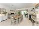 Bright dining room with long table set for eight, open shelving, and seamless flow into the living spaces at 105 Los Cedros Dr, Anna Maria, FL 34216