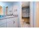 Bathroom vanity next to toilet room with a shower with a seagull-themed curtain at 1080 Peppertree W Ln # 602, Sarasota, FL 34242