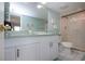 Bright bathroom offering a glass enclosed shower, generous vanity storage, and a large mirror at 1080 Peppertree W Ln # 602, Sarasota, FL 34242