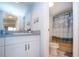 Bathroom vanity next to toilet room with a shower with a seagull-themed curtain at 1080 Peppertree W Ln # 602, Sarasota, FL 34242