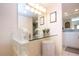 Vanity area with glass block and a makeup mirror next to a wicker basket at 1080 Peppertree W Ln # 602, Sarasota, FL 34242