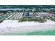 Aerial view of community with private beach access, high rise buildings in background at 1080 Peppertree W Ln # 602, Sarasota, FL 34242