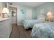 Bright bedroom showcasing two twin beds, hardwood floors, and a closet at 1080 Peppertree W Ln # 602, Sarasota, FL 34242