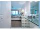 Bedroom with ensuite bath and vanity with a view of the ocean and access to the balcony at 1080 Peppertree W Ln # 602, Sarasota, FL 34242