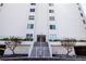 Front entrance of building with stairway, sidewalk, greenery, and lamp post at 1080 Peppertree W Ln # 602, Sarasota, FL 34242
